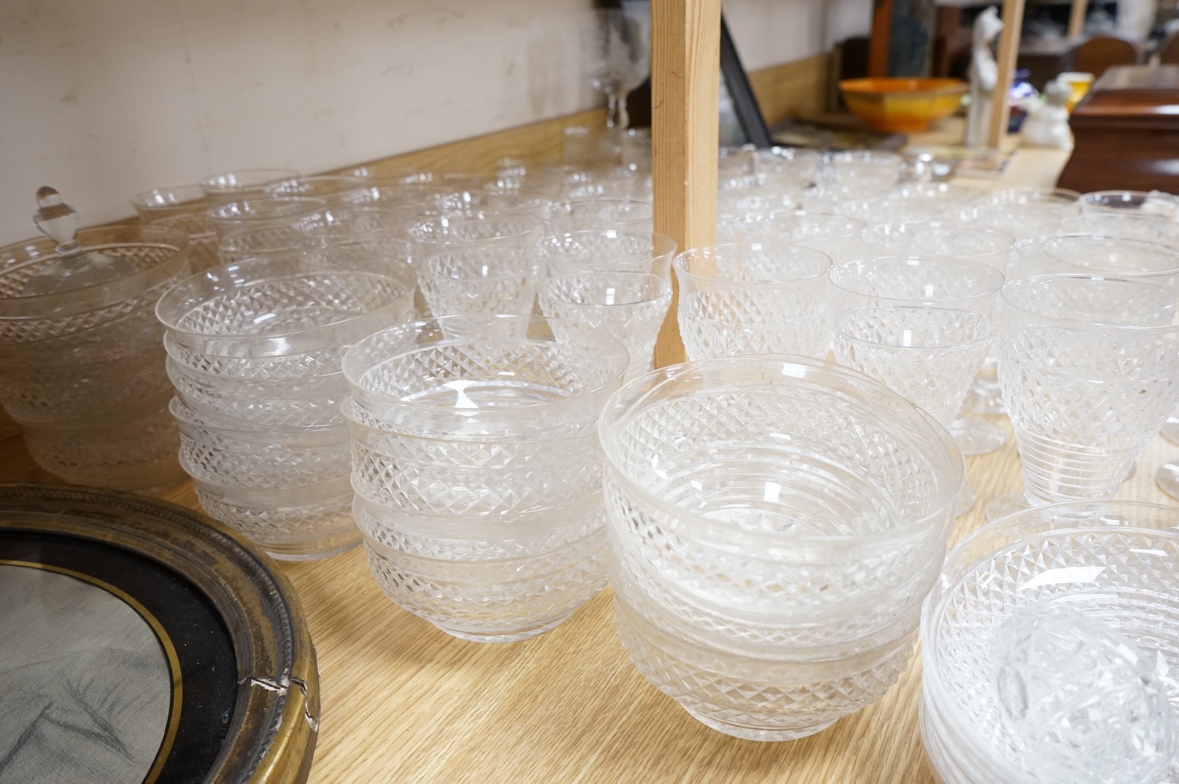 A suite of early 20th century cut table glass, custard glasses, a tall stemmed etched glass, etc., etched glass 24cm high